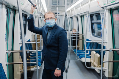 Businessman standing in train