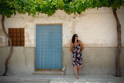 Full length of woman standing on wall