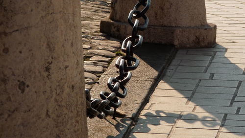 Close-up of rope tied to chain