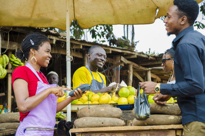 Woman holding fruits for sale at market