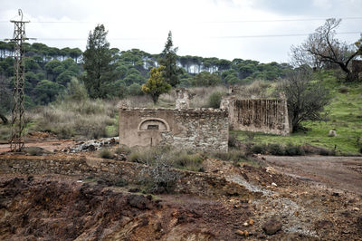 Old ruin on field against sky