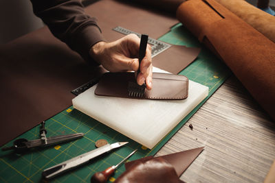 Cropped hand of man working on table