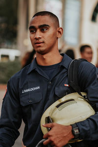 Man in uniform standing outdoors