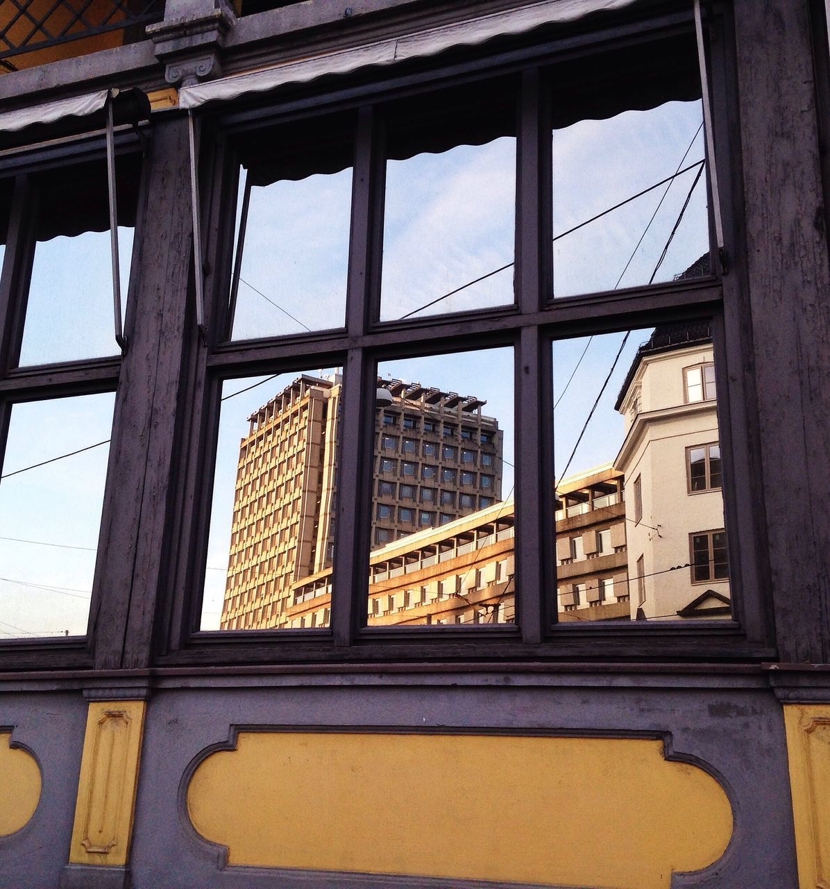 architecture, built structure, window, glass - material, building exterior, indoors, low angle view, sky, transparent, building, geometric shape, no people, day, sunlight, glass, pattern, residential structure, house, city, reflection