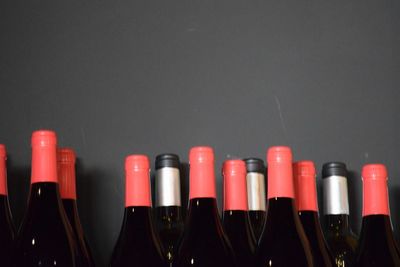 Close-up of wine bottles against gray background