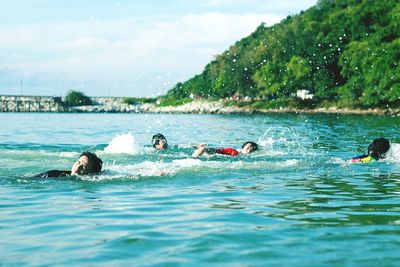 People swimming in sea