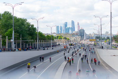 People riding bicycles on road in city