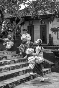 People standing by staircase outside building