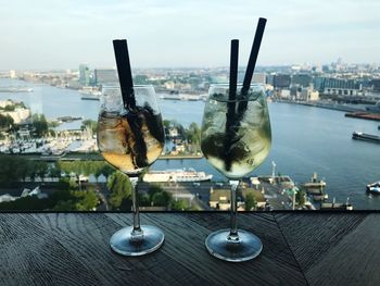 Close-up of drink on table against cityscape