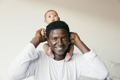 Portrait of man playing with daughter