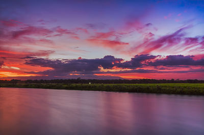 Scenic view of lake against romantic sky at sunset