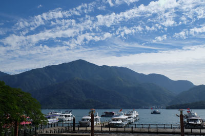 Scenic view of bay and mountains against sky