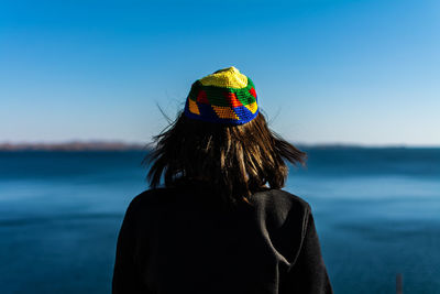 Rear view of woman looking at sea against sky