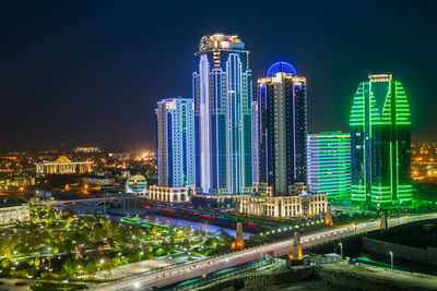 Illuminated modern buildings in city at night. grozny 