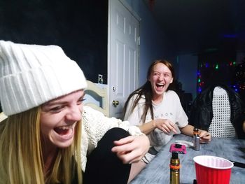 Portrait of smiling girl sitting on sofa at home
