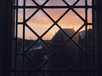 Close-up of chainlink fence against sunset sky