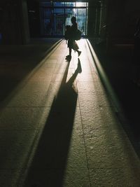 Shadow of man walking on road