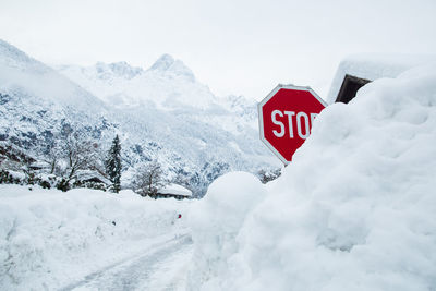 Road sign is covered by snow