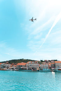 Plane flying over a village