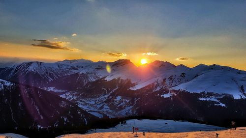 Scenic view of snowcapped mountains against sky during sunset