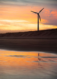 Scenic view of beach against sky during sunset