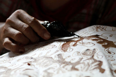 Close-up of human hand holding paper