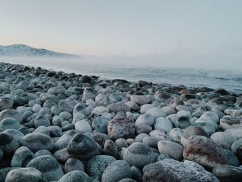 Rocks on beach against sky