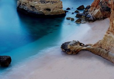 Rocks in sea against sky