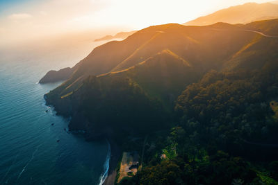 High angle view of sea and mountains against sky