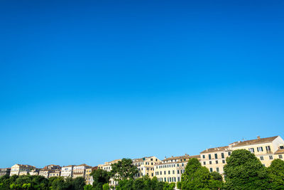 Low angle view of buildings against blue sky