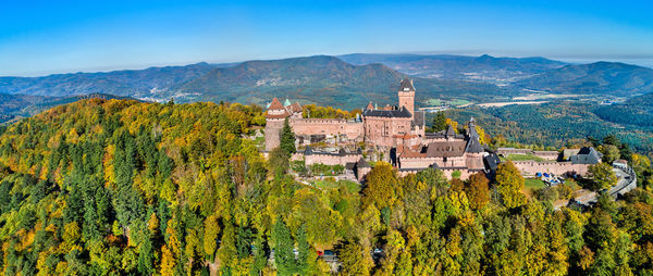 Panoramic view of trees and buildings against sky