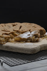 Close-up of cake on table against black background