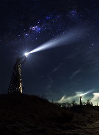 Low angle view of landscape against sky at night