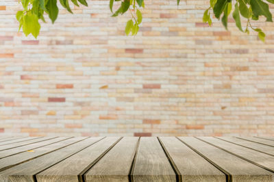 Close-up of table against brick wall