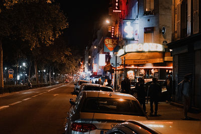 Cars on city street at night