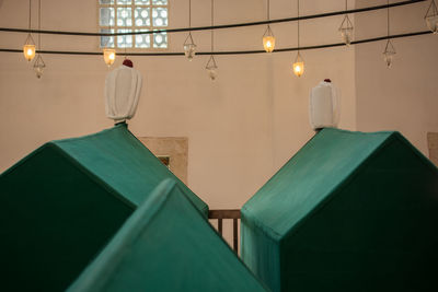 Low angle view of illuminated pendant light hanging from ceiling