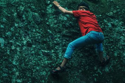 Low angle view of man climbing on wall