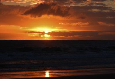Scenic view of sea against romantic sky at sunset