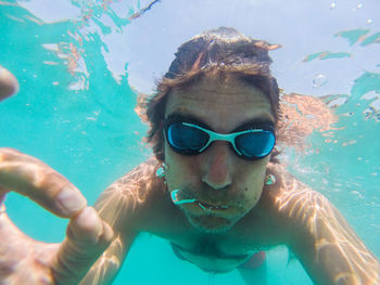 Portrait of man swimming in sea