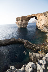 Rock formation at gozo island against clear sky