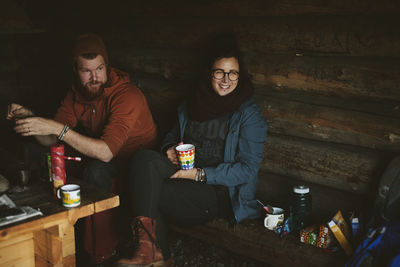 Couple resting with hot drinks