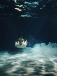 Portrait of young man swimming in sea