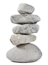 Close-up of stone stack against white background