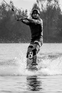 Full length of man splashing water