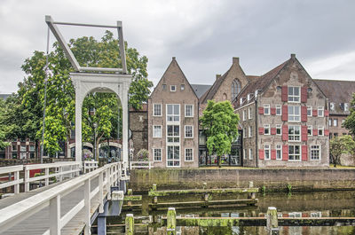 View of canal by building against sky