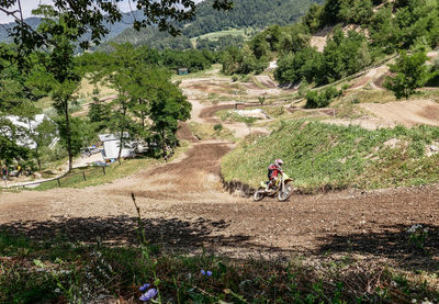 Man riding motorcycle on landscape against mountain