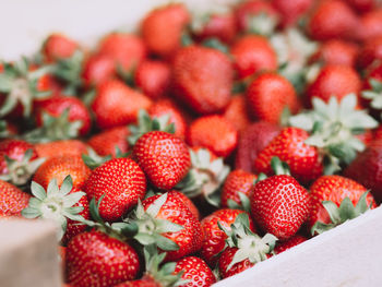 Big wooden box with ripe fresh strawberries background. harvest close up