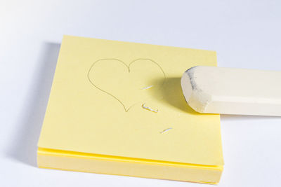 Close-up of paper on table against white background
