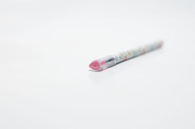 Close-up of cigarette against white background