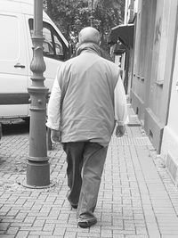 Woman standing on footpath